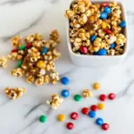 Homemade Spicy caramel popcorn with peanut M&Ms photo