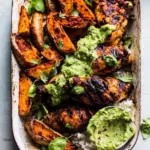 homemade Sheet Pan Lemon Chicken with Sweet Potatoes and Avocado Goddess Sauce. photo
