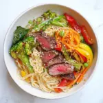 Homemade Asian Veggie Noodle Bowl with Grilled Steak recipe photo