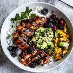 Homemade BBQ Chicken and Grilled Corn Rice Bowls with Berry Smashed Avocado. food shot