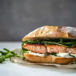 Homemade Easy Baked Salmon Sandwich with Zesty Lemon Mayo and Arugula photo