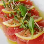 Homemade Tuna Carpaccio with Basil Oil, Lemon and Caper Berries photo