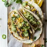 Homemade Two Layer Guacamole and Chipotle Chicken Tacos. recipe photo